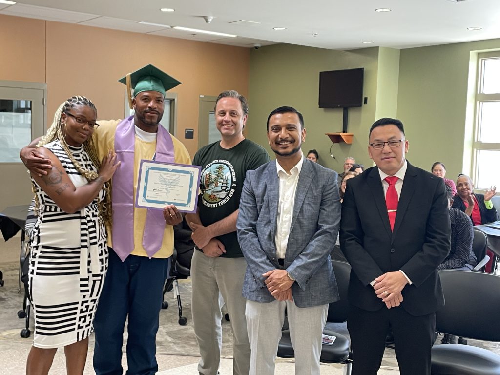 A grad with his family and CHCF staff