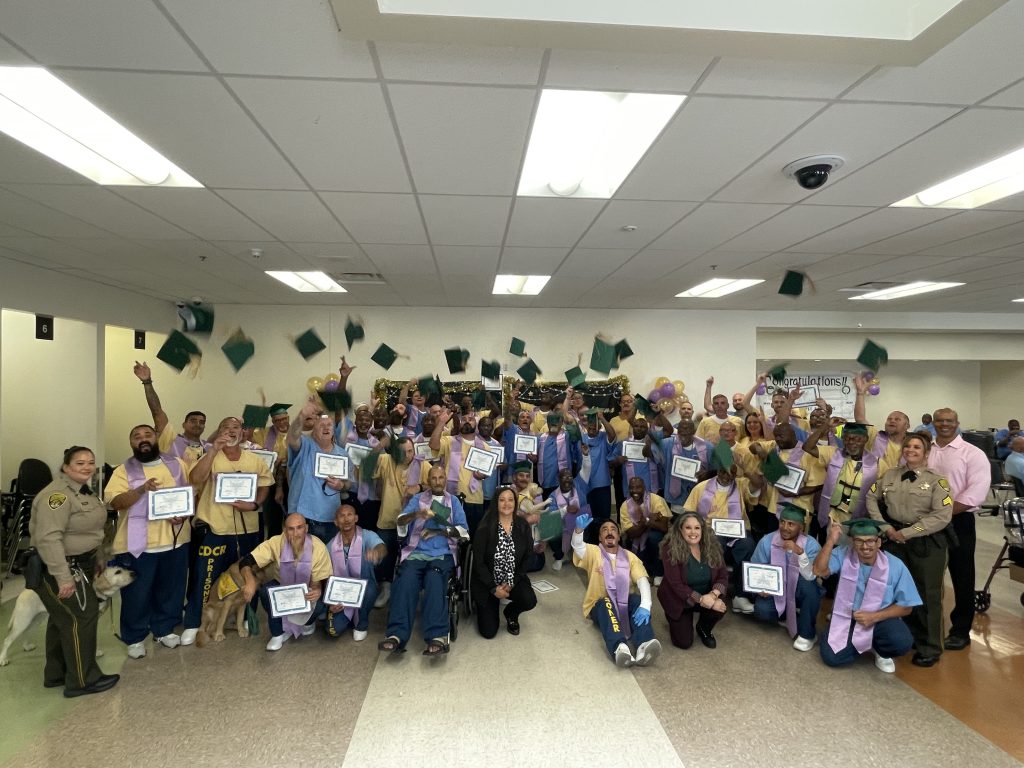 Grads celebrating and throwing caps in the air