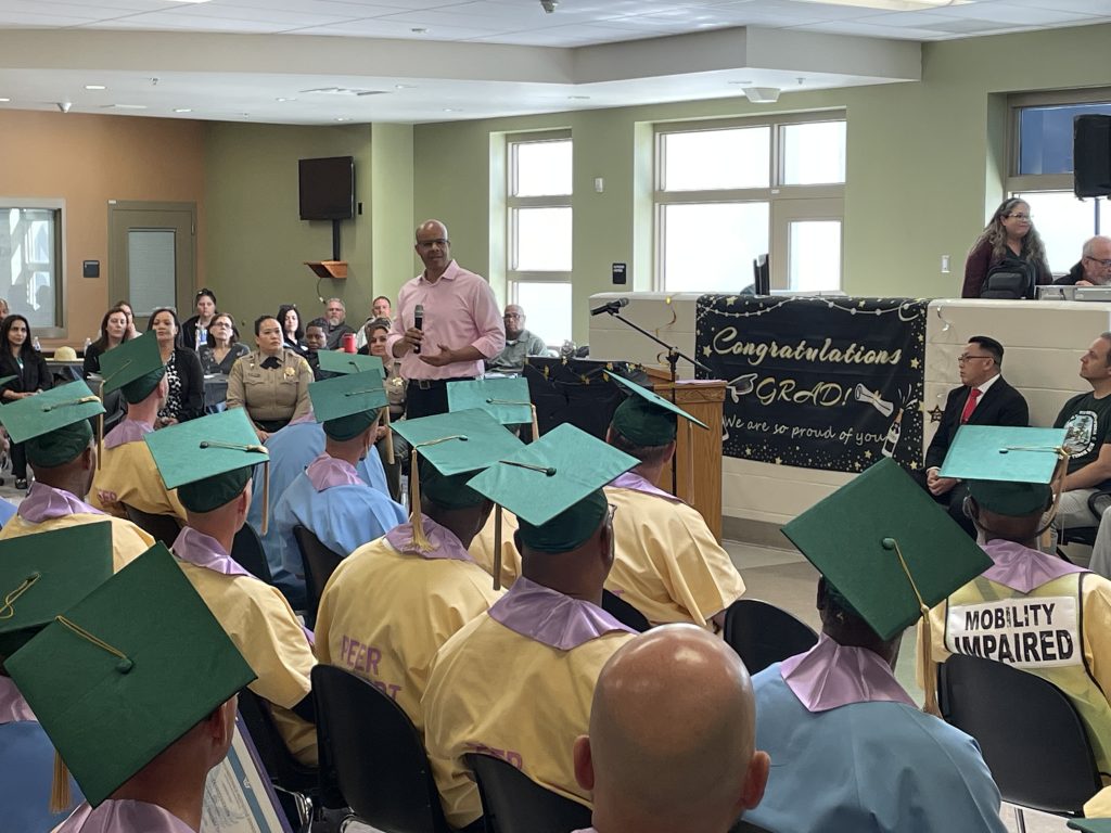Speaker talking to grads