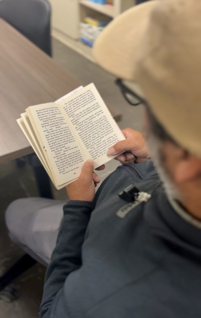 An incarcerated student reads a book at California Men's Colony at San Luis Obispo.