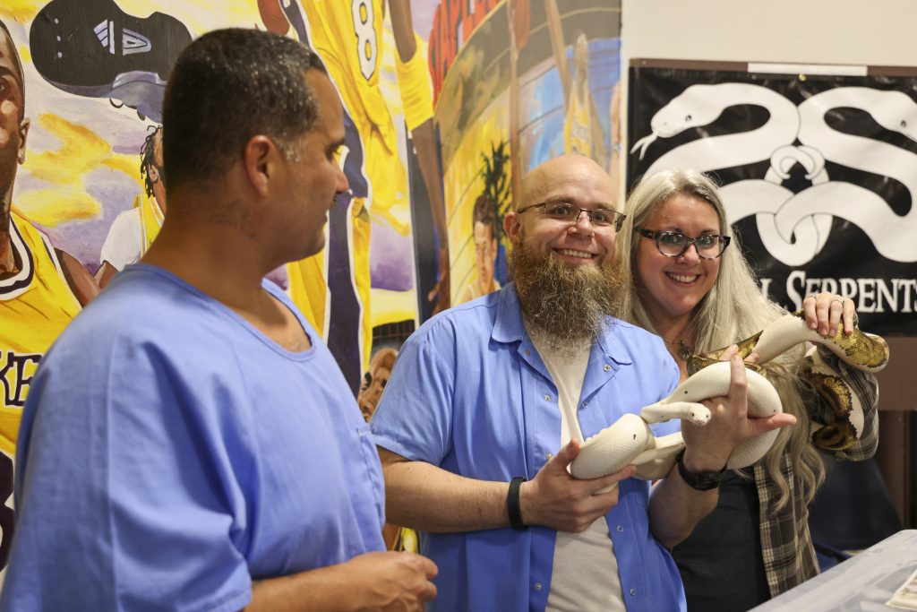 People holding a snake at the CTF cultural fair. 