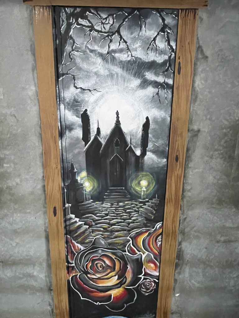 Plumbing chase door painting by artist at High Desert State Prison.