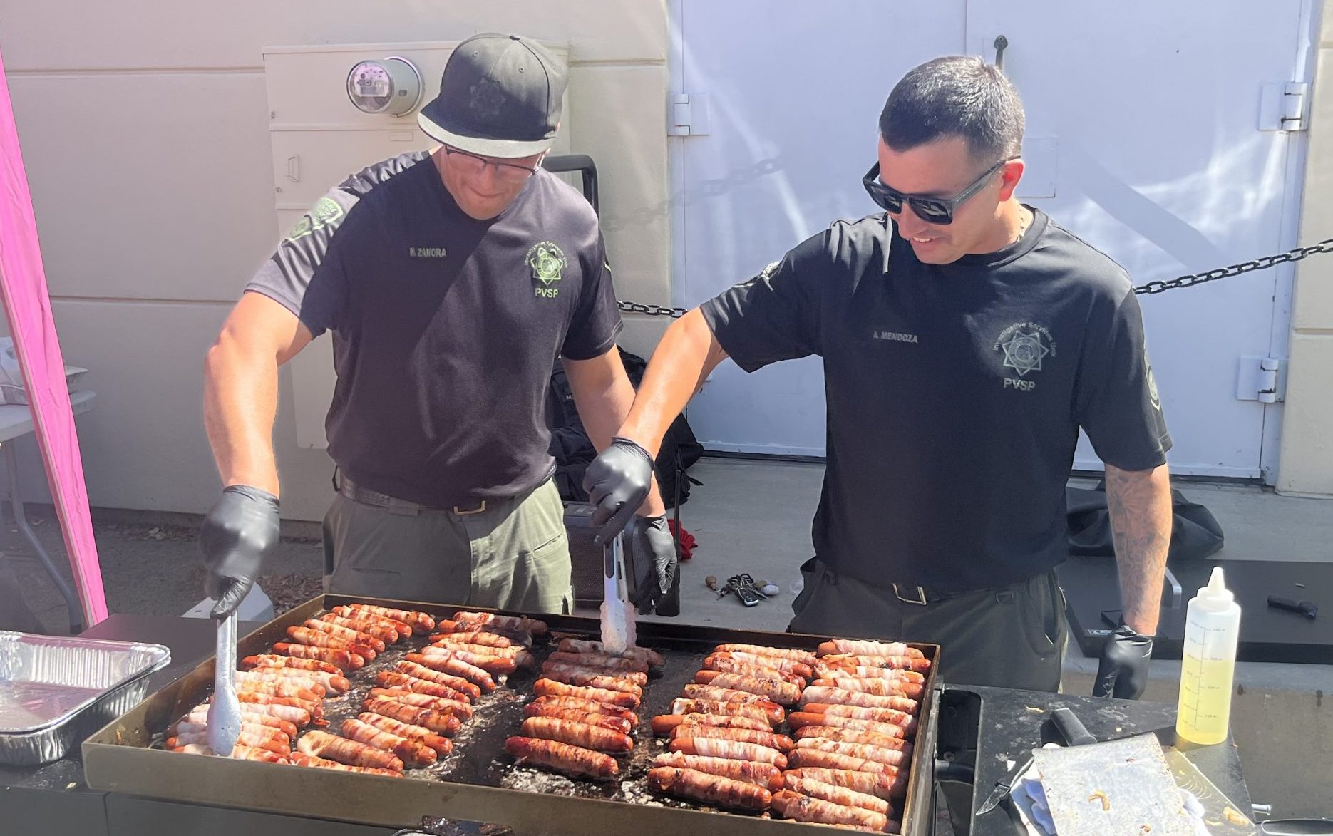 PVSP Employee Action Committee holds a fundraiser, grilling bacon-wrapped hotdogs, to boost staff morale and fund more staff and family events.