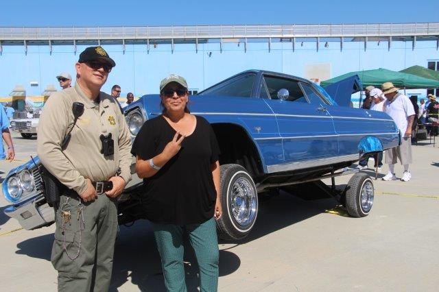Two staff members at the RJ Donovan low and slow car show featuring lowriders on Facility E. 