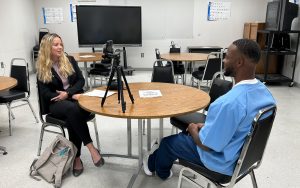 Information Officer Ashton Harris interviews an incarcerated student at Salinas Valley State Prison, a Level IV institution.