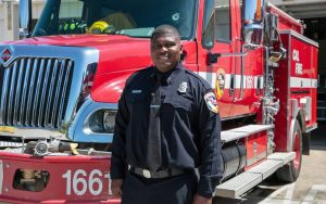 CAL FIRE employee Troy Senegal with a fire engine.