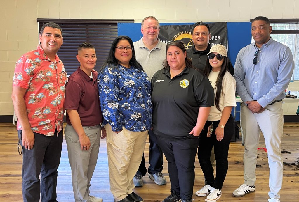 Valley State Prison staff and a church gathered school supplies for children, distributing them at a community park.