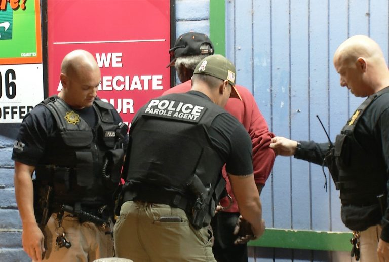 A person is arrested by parole agents during Operation Boo 2017.