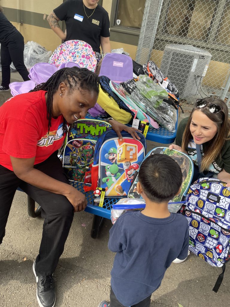 CHCF staff donating backpack to local boy
