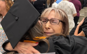 An incarcerated student receives a hug at their CIW Cal State LA graduation on Oct. 3, 2025.