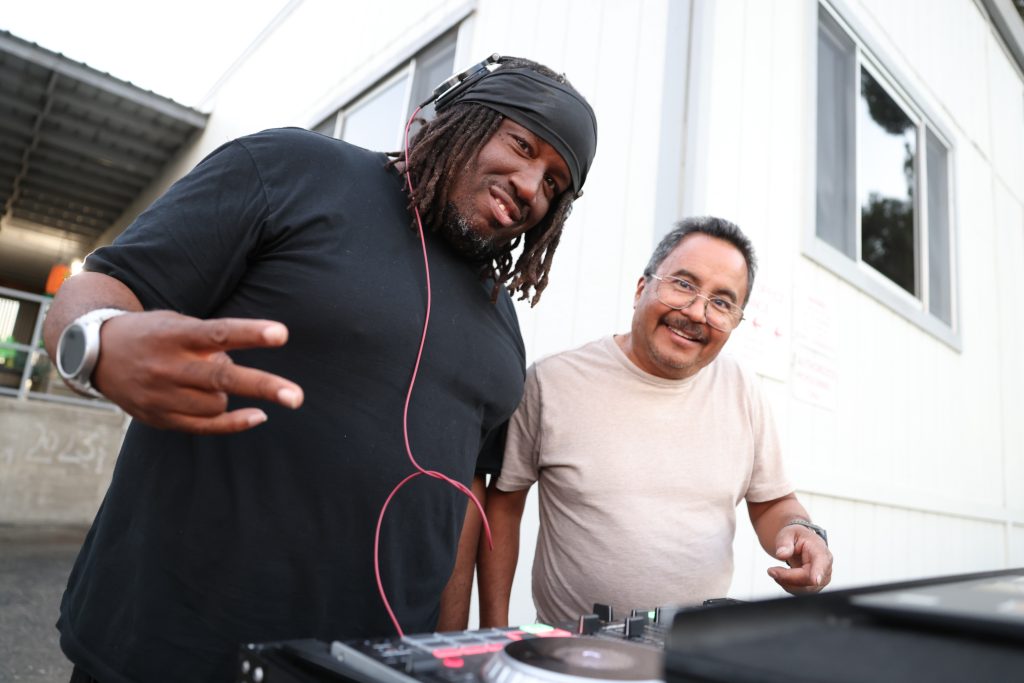 Two staff members as DJs at the CMF, CSP-Solano trunk-or-treat Halloween and harvest festival for staff and their families, Oct. 29, 2025, in Vacaville, Calif.