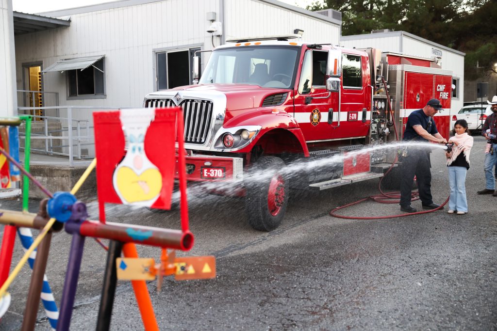Target practice with a firehose at the CMF, CSP-Solano trunk-or-treat Halloween and harvest festival for staff and their families, Oct. 29, 2025, in Vacaville, Calif.