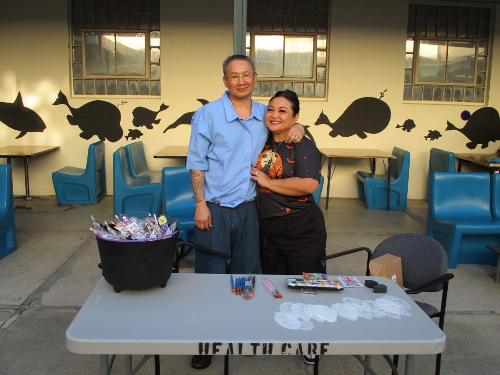 an incarcerated person hugging their loved one