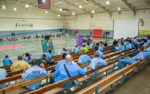 Incarcerated people, staff, and community members attend poetry night at CMF.