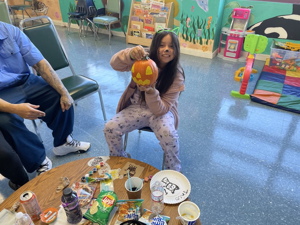Minor decorating a pumpkin