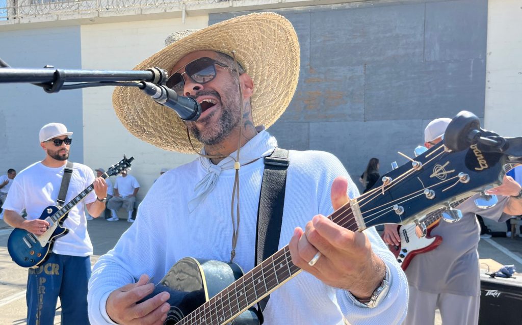 International Overdose Awareness Day at Folsom State Prison with a person performing on a guitar.