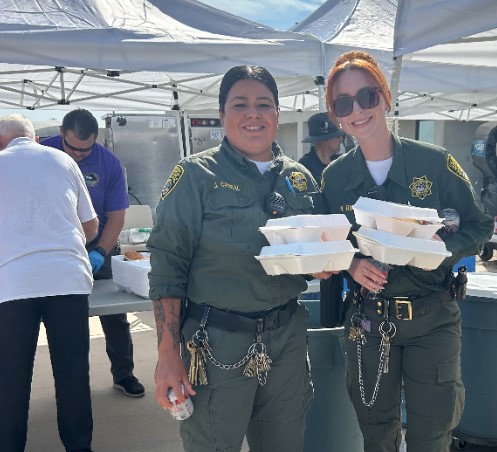 Officers with food served during a staff appreciation barbecue at Ironwood State Prison.