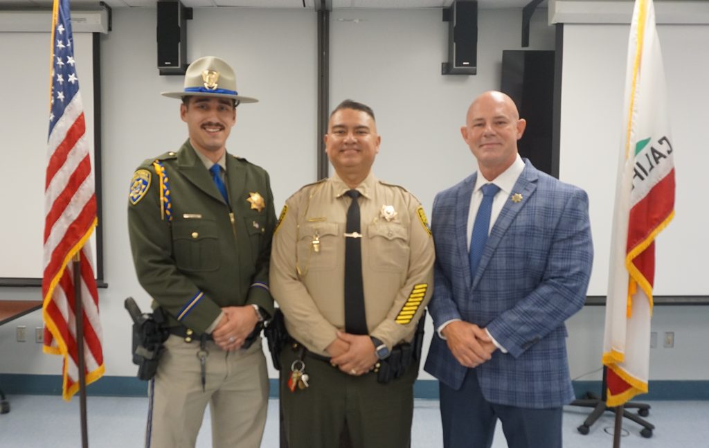 A new lieutenant with his son and the warden at Kern Valley State Prison's promotion ceremony.