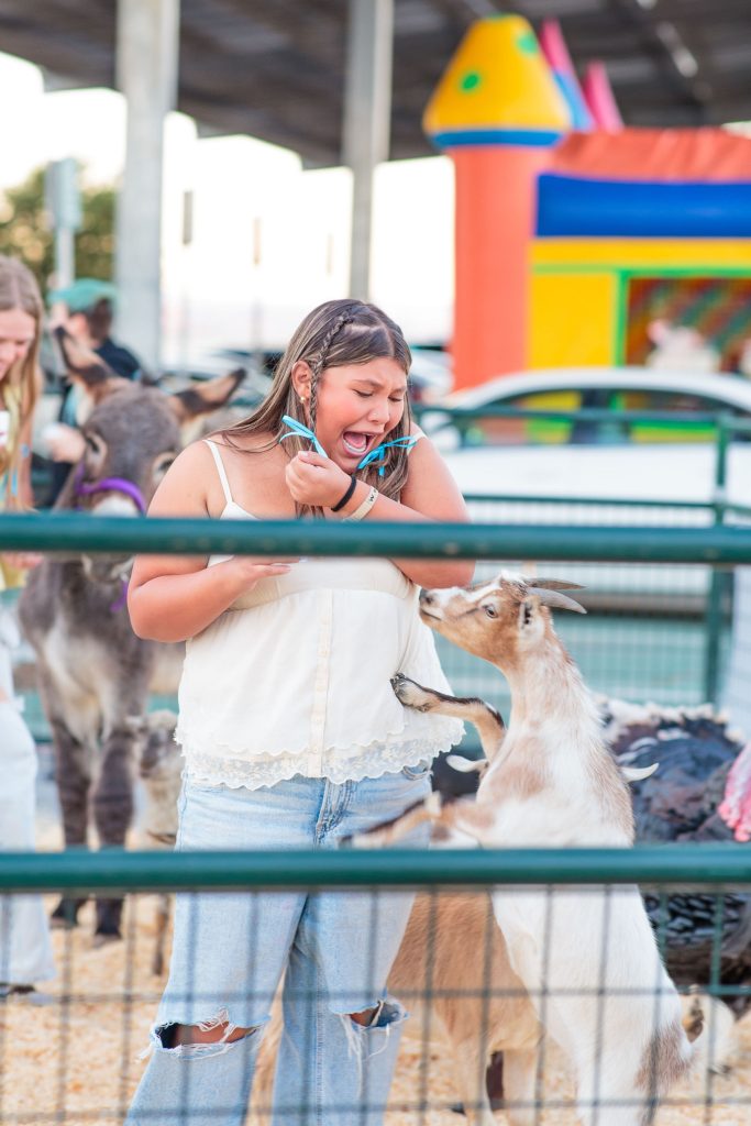 person visiting a goat