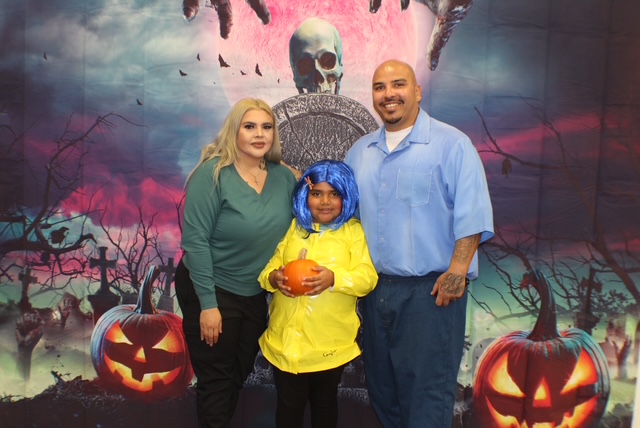 Family posing for a Halloween visiting photo at MCSP in Ione.