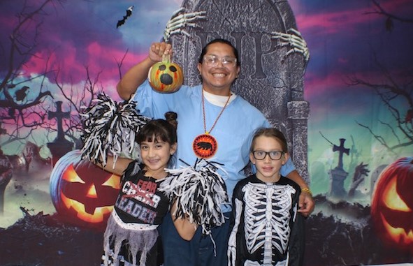 Family takes photo with Halloween background at Mule Creek State Prison in Ione.