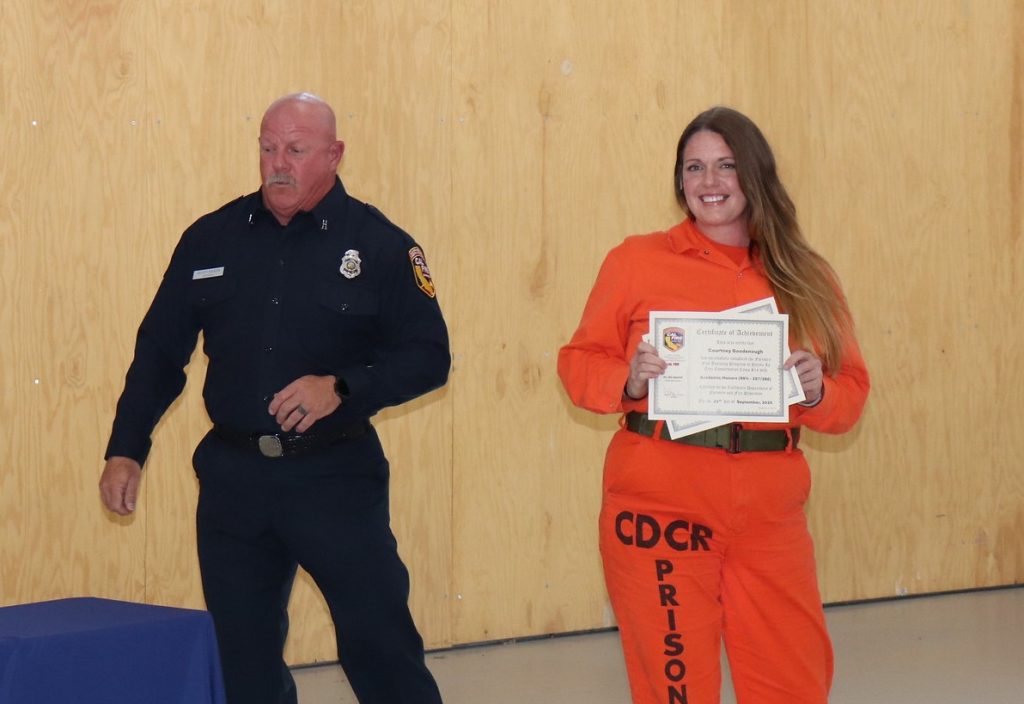 One of the graduates holds her certificate at Puerta La Cruz Conservation Camp.