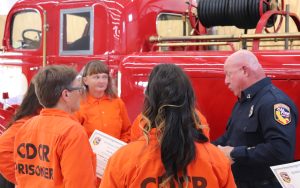 Puerta La Cruz graduation with a CAL FIRE leader presenting certificates.