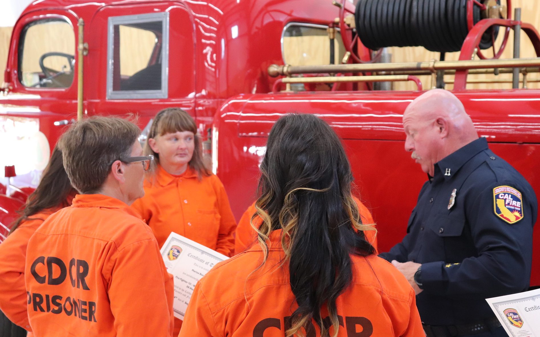 Puerta La Cruz graduation with a CAL FIRE leader presenting certificates.