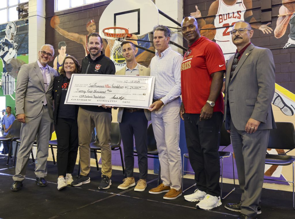 Solano presents a check for $24,000 raised by the population.