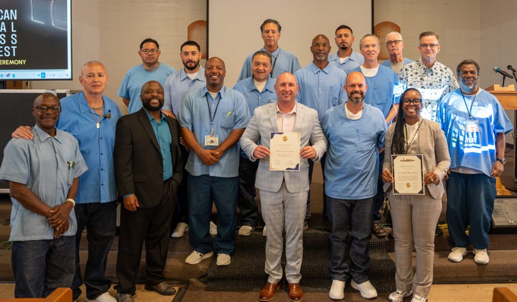 Group photo of staff and incarcerated people at San Quentin Rehabilitation Center.
