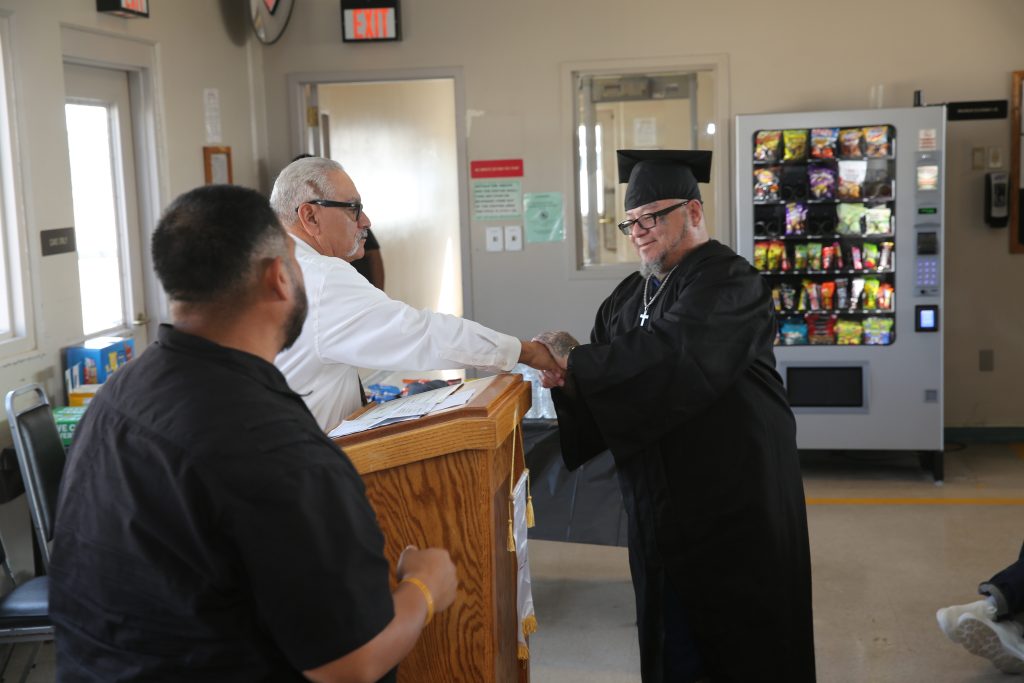 ISUDT graduate shaking hands