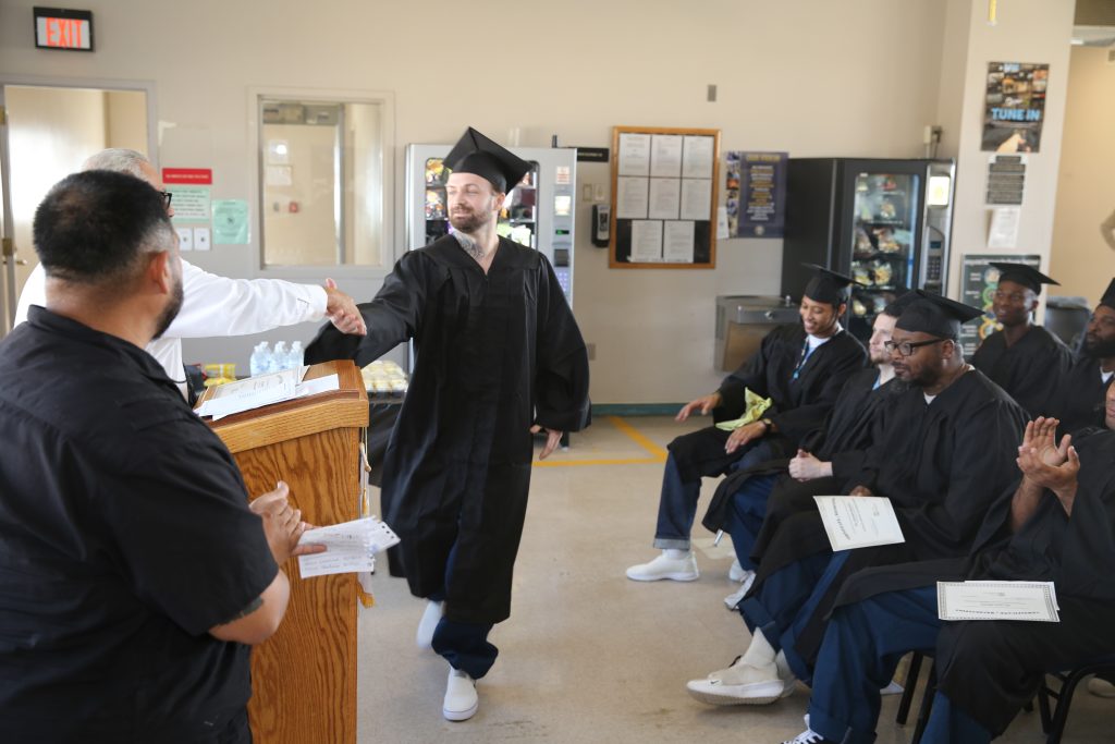 ISUDT graduate shaking hands