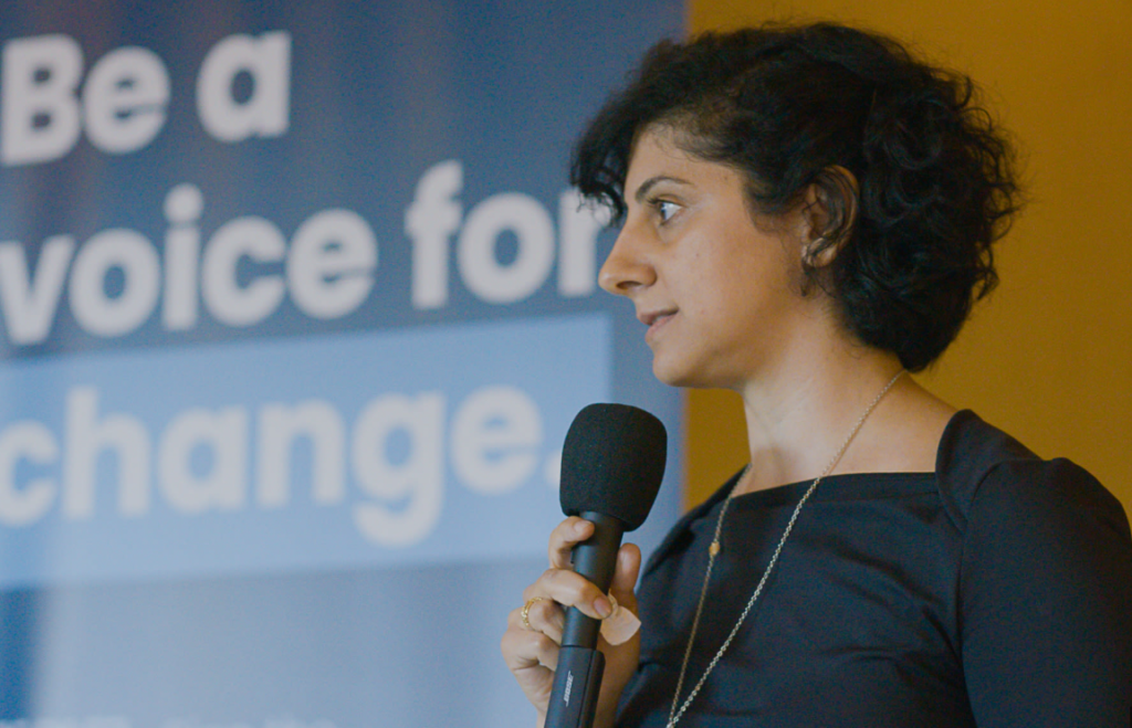 Woman speaking into a microphone