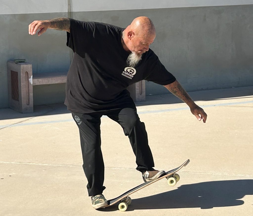 Skateboard rider performs tricks at the Dennis Martinez rehabilitation event at Ironwood State Prison.