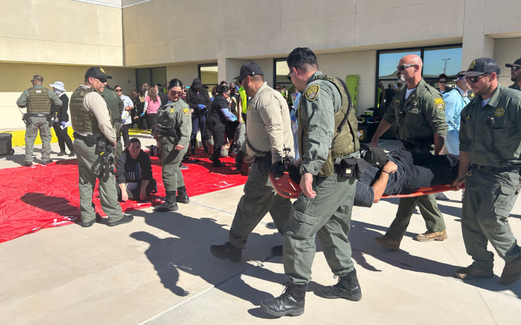 Staff carry mock patients to a triage area during the mass casualty training at Ironwood State Prison.