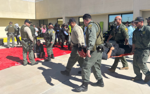 Staff carry mock patients to a triage area during the mass casualty training at Ironwood State Prison.