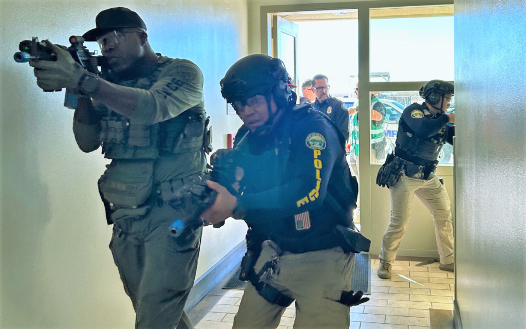 Police officer and CDCR staff member clear the building using training weapons.