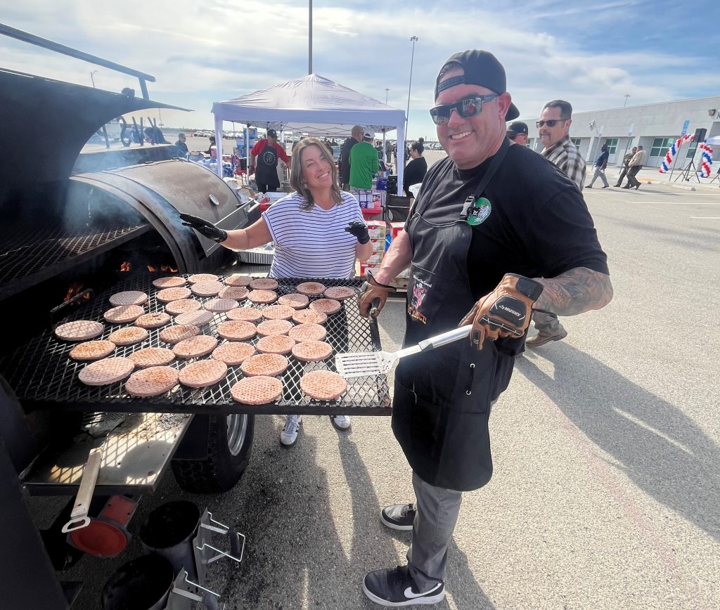 Associate Warden Nuckles and Supervising Registered Nurse III J. German grilling burgers for staff at KVSP.
