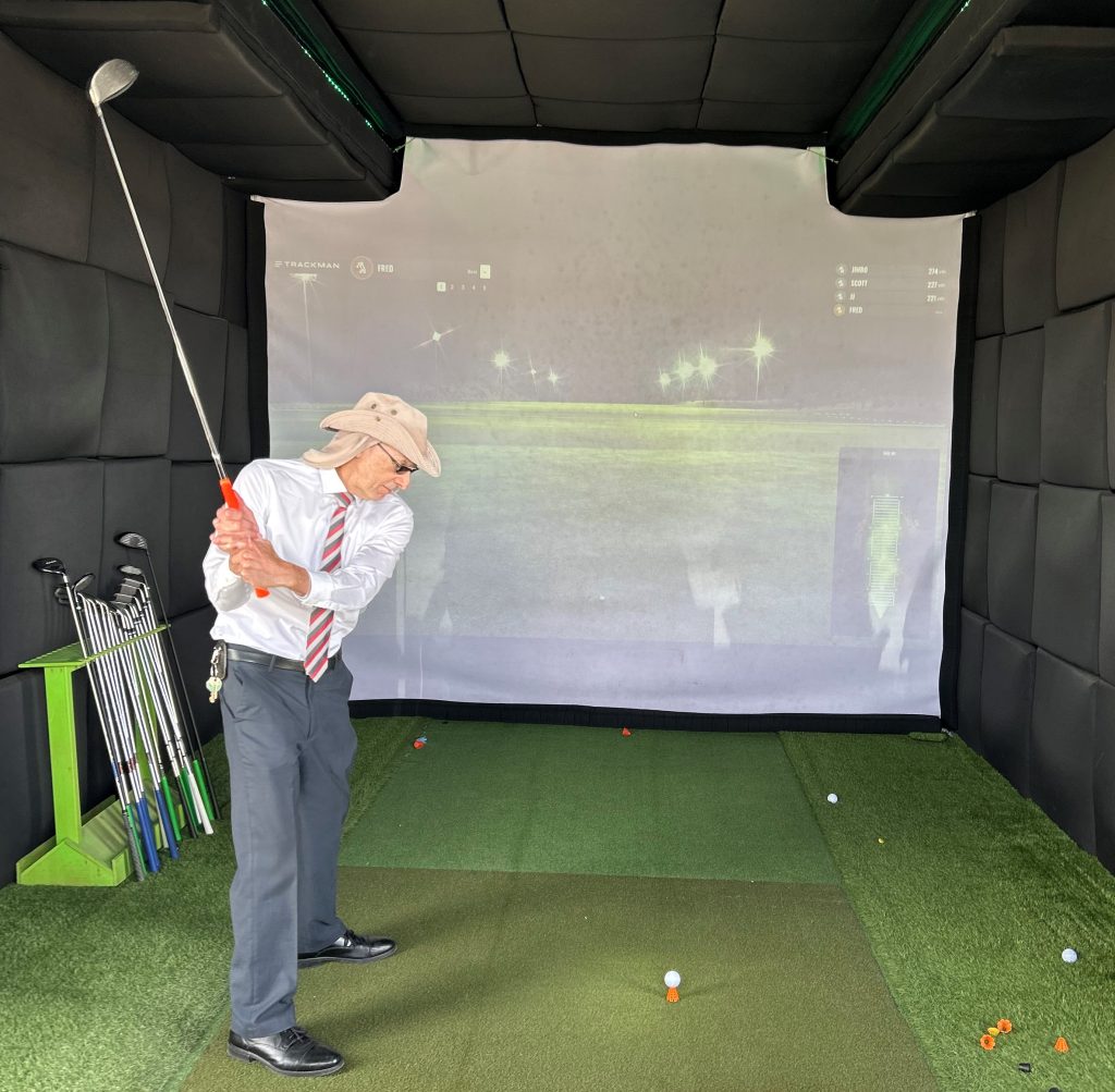 Golf simulator with KVSP CEO F. Beyerlein trying out a swing.