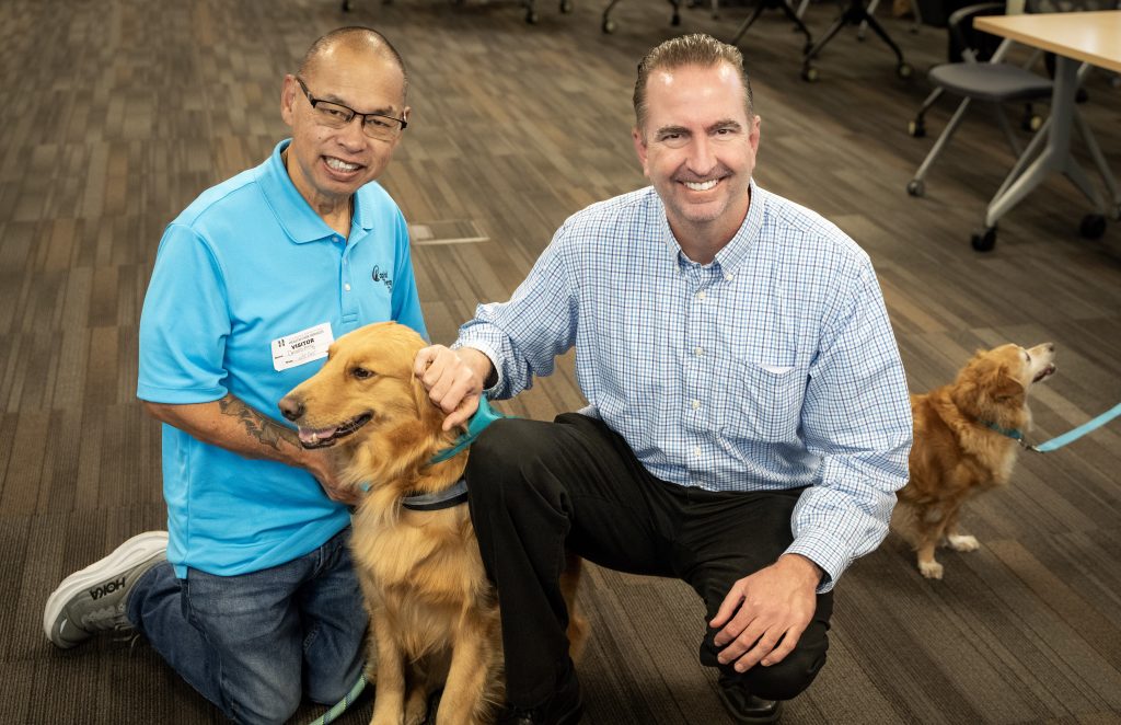 Secretary Macomber with a volunteer and a dog. at the Our Promise event at CDCR and CCHCS headquarters in November 2025.