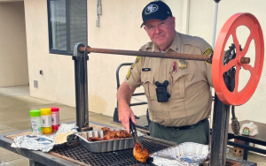 Correctional officer grills chicken during the second Substance Abuse Treatment Facility and State Prison (SATF) Barbecue Brawl in Corcoran, California, on Nov. 14, 2025.