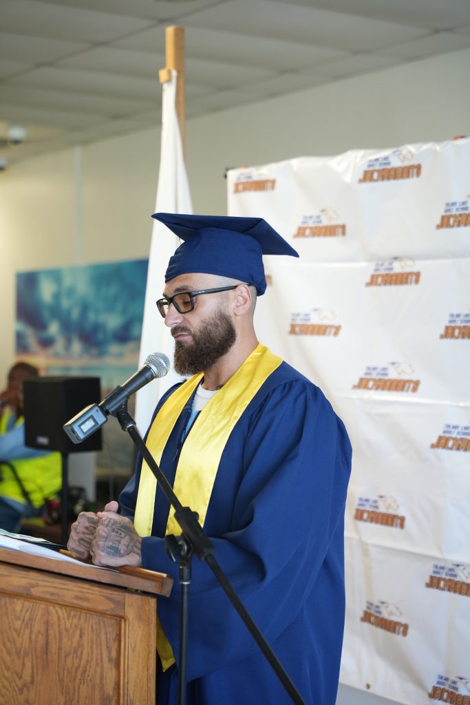 incarcerated graduate speaking at graduation ceremony
