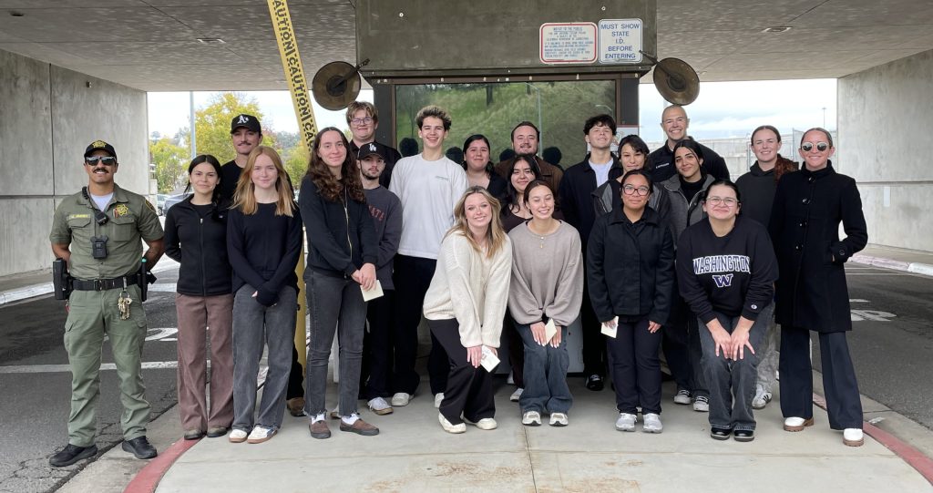 FLC students and correctional officer at the front gate of CSP Sac