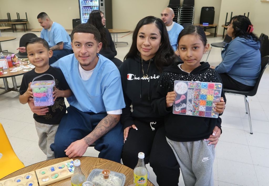 Children holding gifts at Avenal State Prison during Christmas Day visiting. 