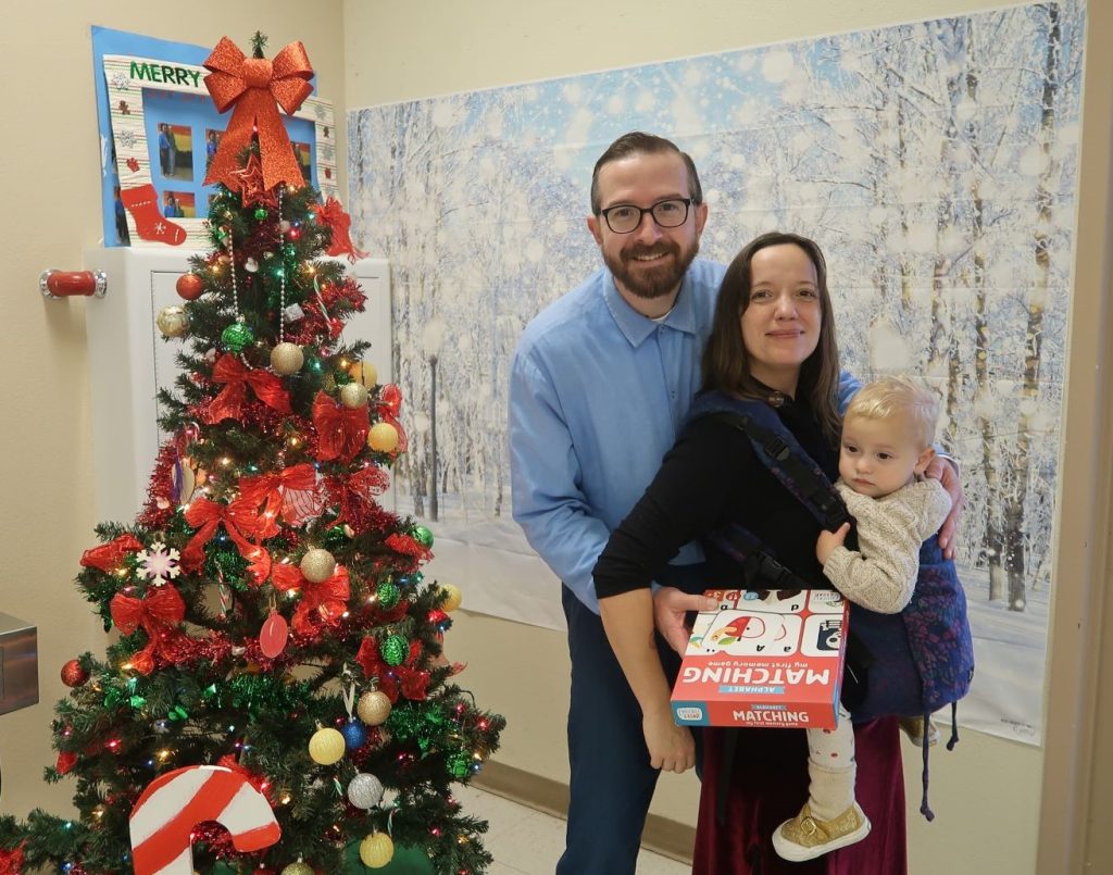 An incarcerated person, a woman, and a baby at Avenal State Prison. 
