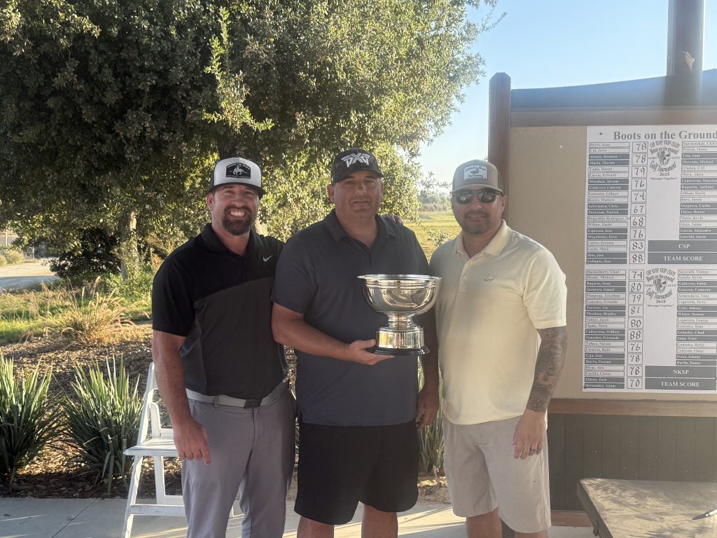 Winning SATF team in golf tournament holding a trophy