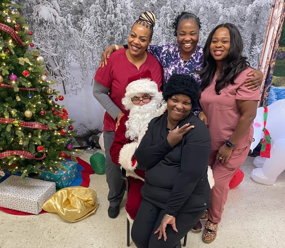 CMF staff posted for photos with Santa. 