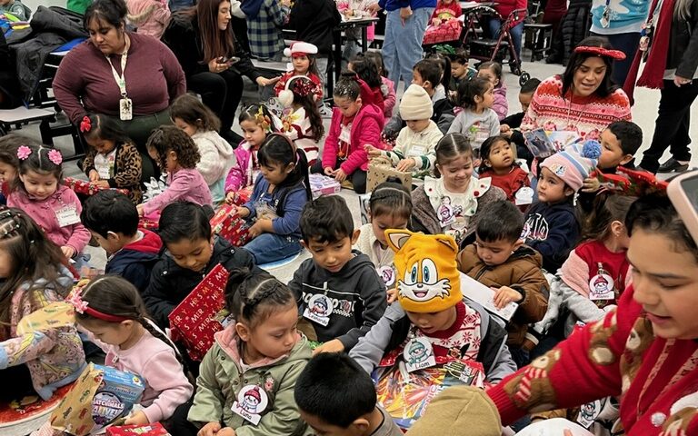 Large number of students open their gifts from CSP-Corcoran.