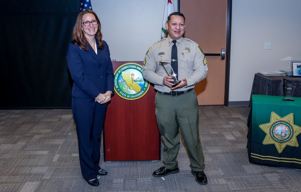 Undersecretary Barretto with sergeant receiving Impact Award in Sacramento.