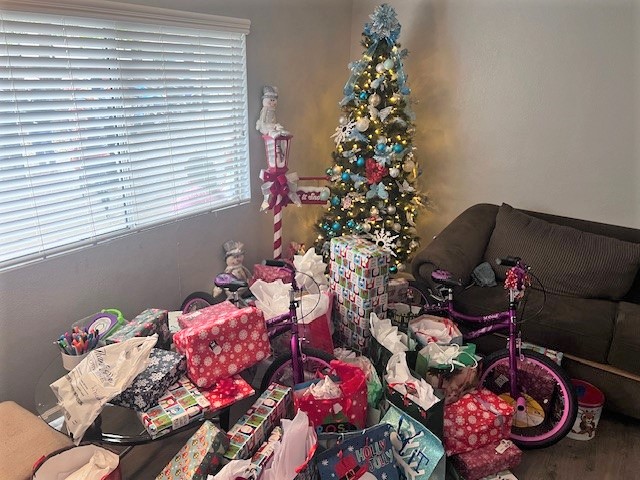 Gifts under a tree for a family thanks to the youth empowerment association and CDCR volunteers from Classification Services and Population Management units.